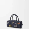 Bolso corto Cats Amazona 23 en mezclilla bordada Bolso corto Cats Amazona 23 en mezclilla bordada