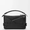 Bolso Puzzle grande estilo motero en piel de becerro brillante Bolso Puzzle grande estilo motero en piel de becerro brillante
