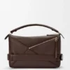 Bolso Puzzle grande estilo motero en piel de becerro brillante Bolso Puzzle grande estilo motero en piel de becerro brillante