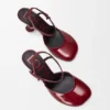 Zapatos de tacón con correa al tobillo «Toy Pump» en piel de cordero charol suave Zapatos de tacón con correa al tobillo «Toy Pump» en piel de cordero charol suave